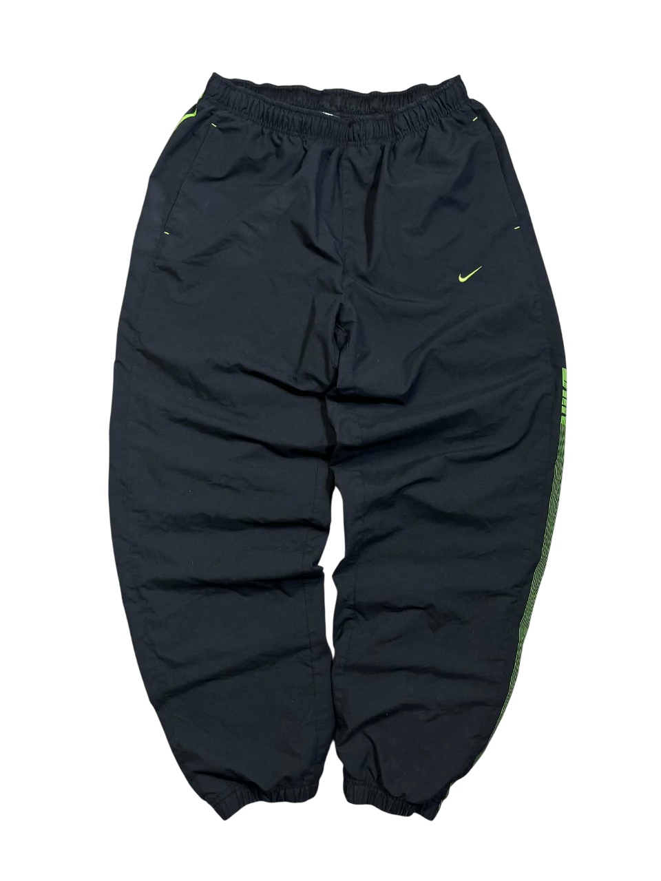 Fekete vintage Nike melegítőnadrág zöld logóval, elasztikus derék és bokarész.