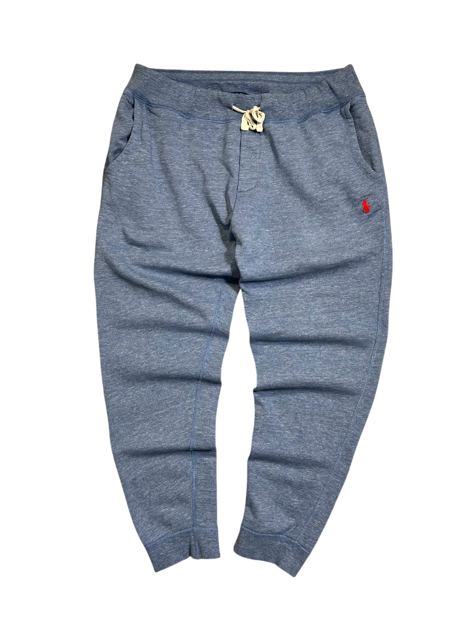 Kék, vintage stílusú melegítőnadrág zsebekkel és piros logó hímzéssel, streetwear divat